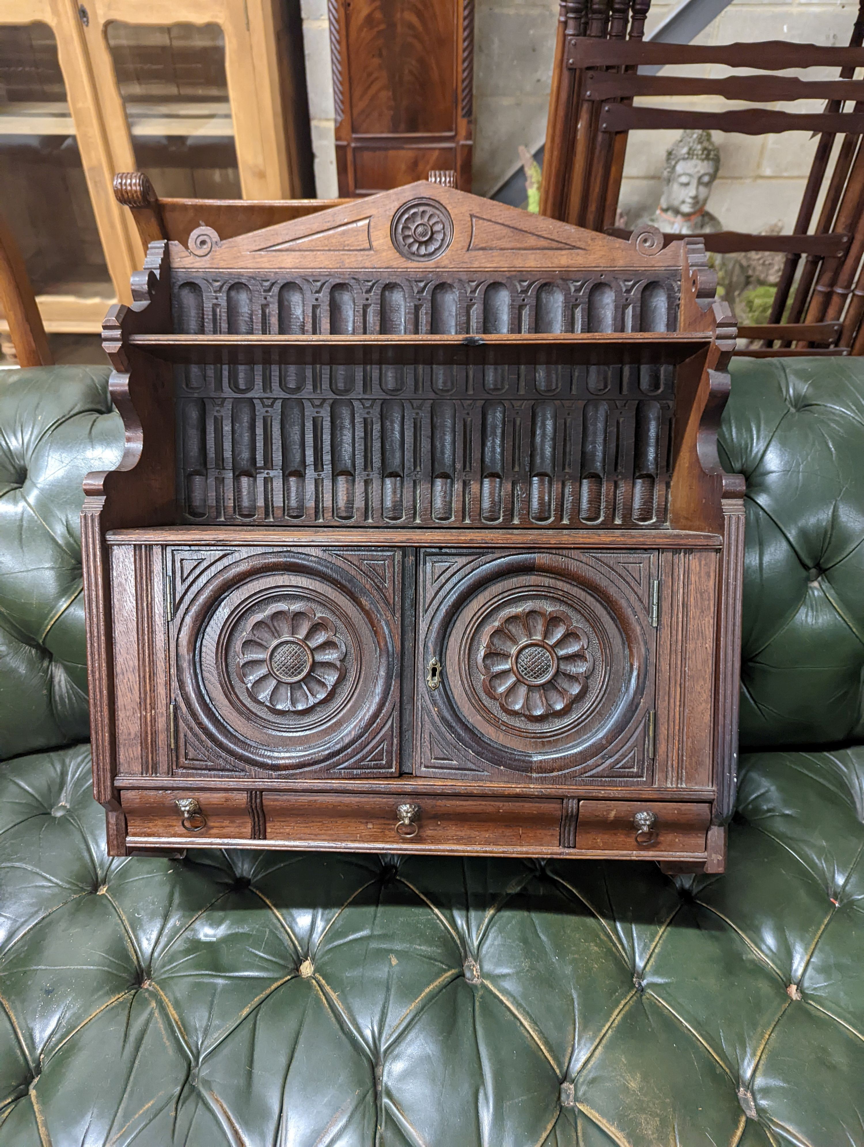 A Victorian carved oak Arts and Crafts wall cabinet, width 55cm, depth 18cm, height 68cm